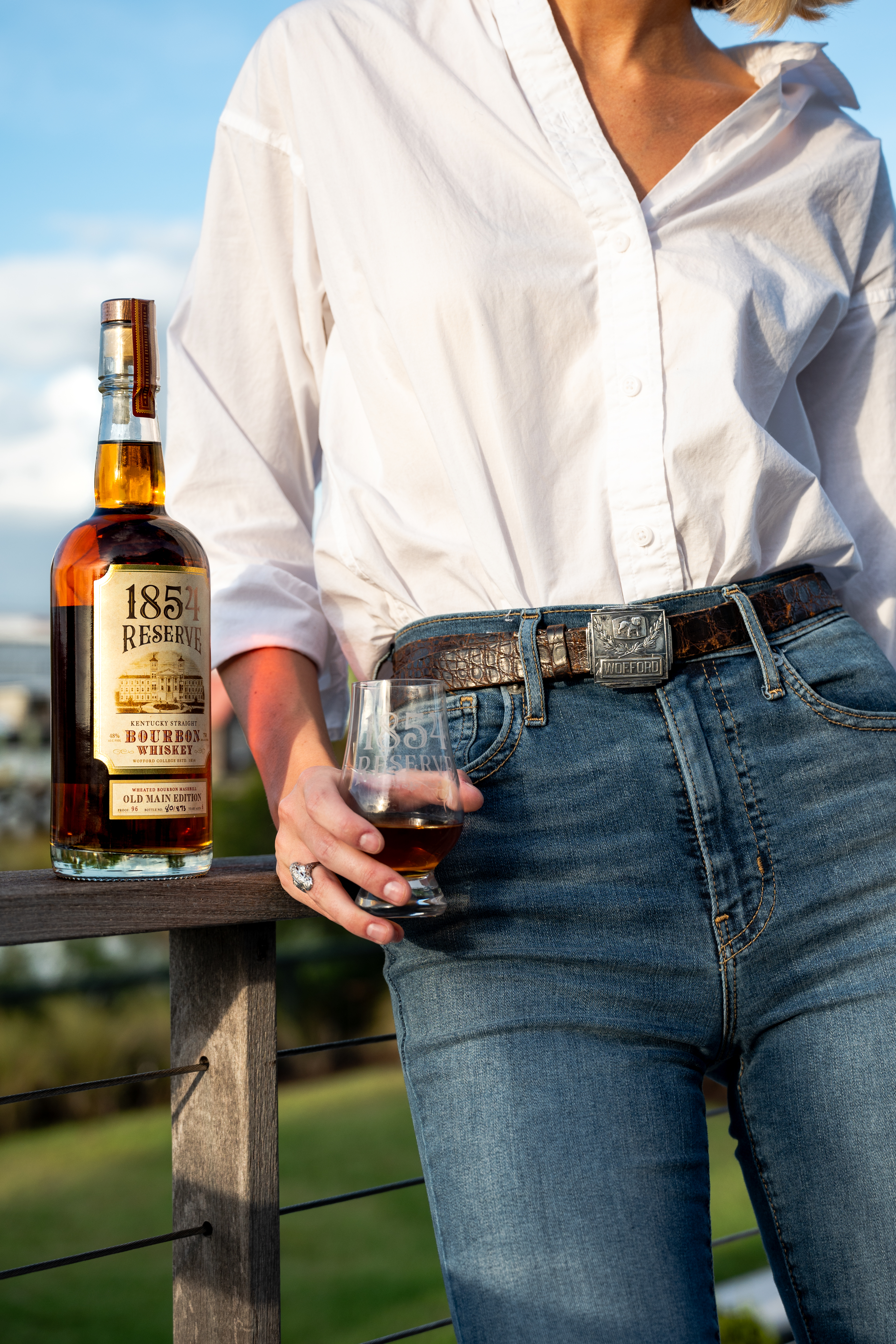 Person enjoying a glass of 1854 Reserve bourbon